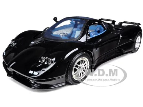 Black diecast model car, front 3/4 view with blue interior