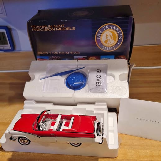 Red classic diecast model car in display box with Franklin Mint logo