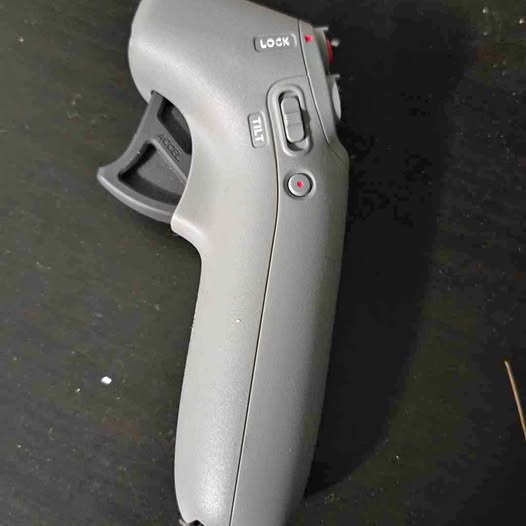 Silver drone motion controller with grip trigger and lock button