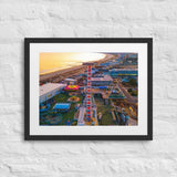Framed matte print of coastal pier aerial view at sunset