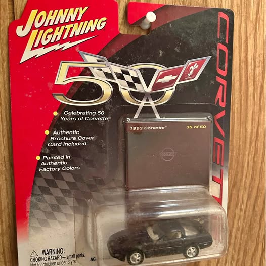 Black Chevrolet Corvette 50th anniversary diecast model car in blister packaging