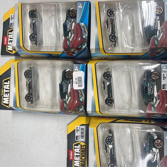 Diecast toy cars in clear blister packs, multiple vehicles in assorted colors