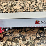 Diecast tractor-trailer replica with red cab, white trailer side and wheels