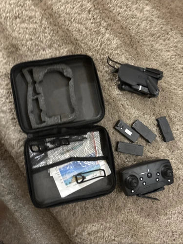 Mini FPV drone controller and parts in black carrying case