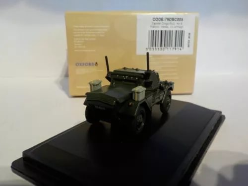 Dark green diecast armored vehicle model with turret on black display base