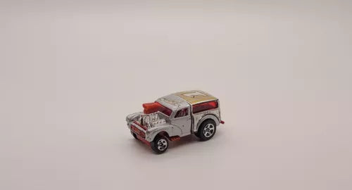 Gray diecast toy SUV with red roof and black wheels