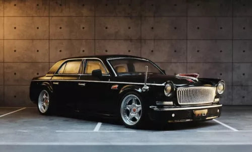 Black diecast luxury sedan model with chrome grille, front three-quarter view