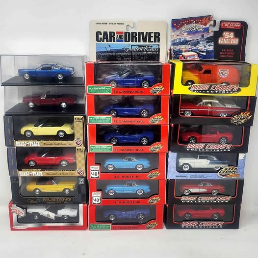 Boxed diecast car collection set with multiple classic muscle cars in displays