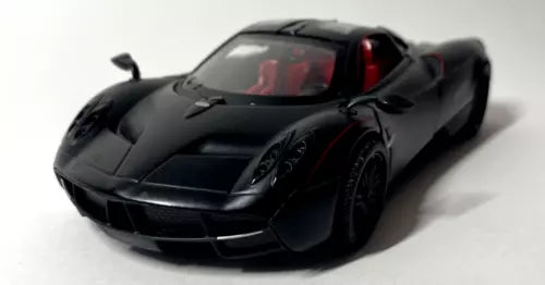 Matte black diecast model car with red interior, front 3/4 view