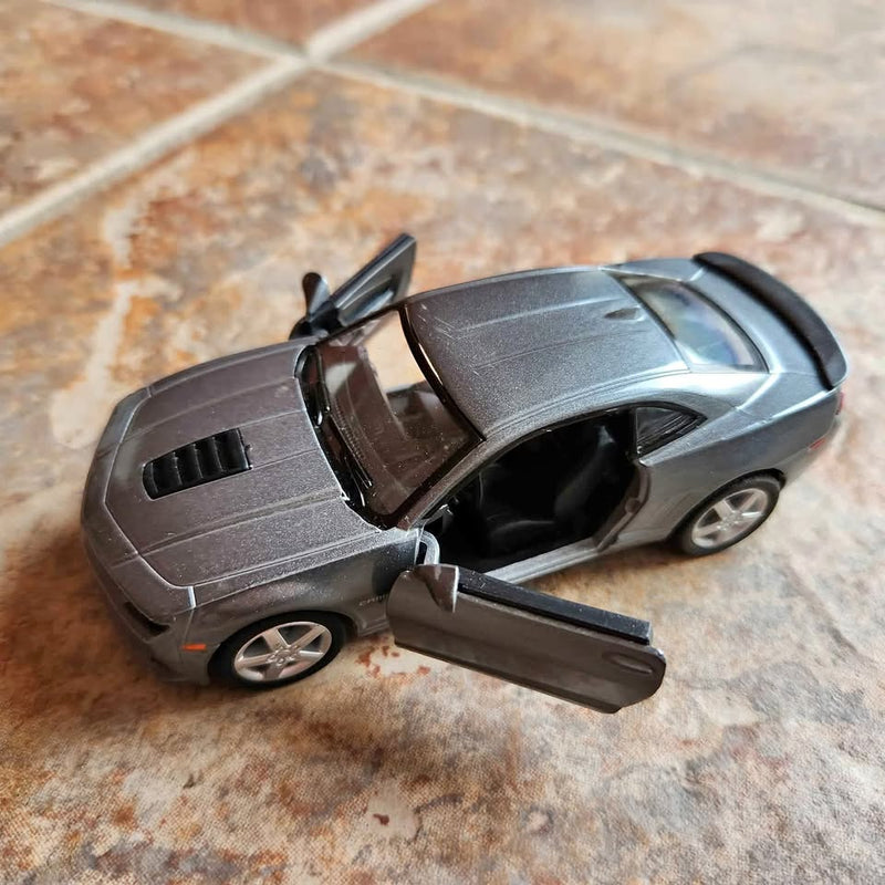 Gray die-cast sports car model with open door and detailed wheels, grille, and hood.