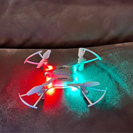 Pocket drone with glowing LED lights, four propellers visible