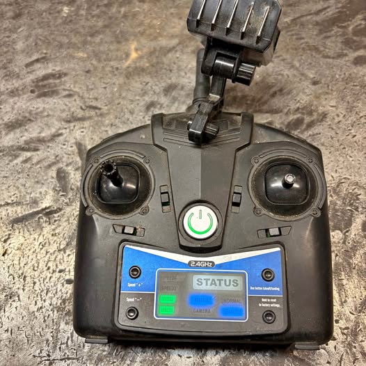 Drone remote control with dual joysticks, screen, and 2.4GHz indicator, dark gray