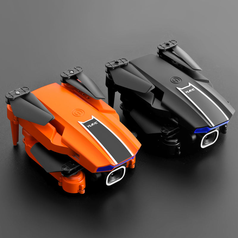 Small quadcopter drone with built-in camera, orange and gray body, visible front lens