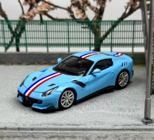 Blue sports diecast model car with white and red racing stripes, black hood vents.