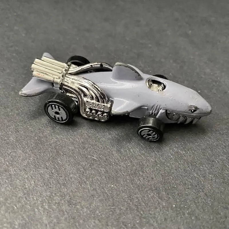 Hot Wheels grey diecast sharkruiser car with side fins and detailed engine, small wheels