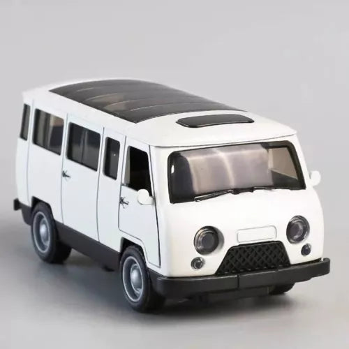 White alloy diecast toy bus with black grille, front headlights, and side windows