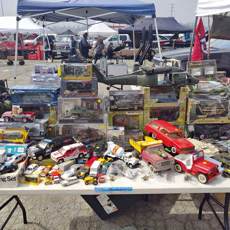 Military diecast car and truck model kits display with boxed vehicles and trucks