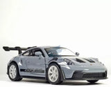 Grey alloy diecast model car with front 3/4 view and raised door