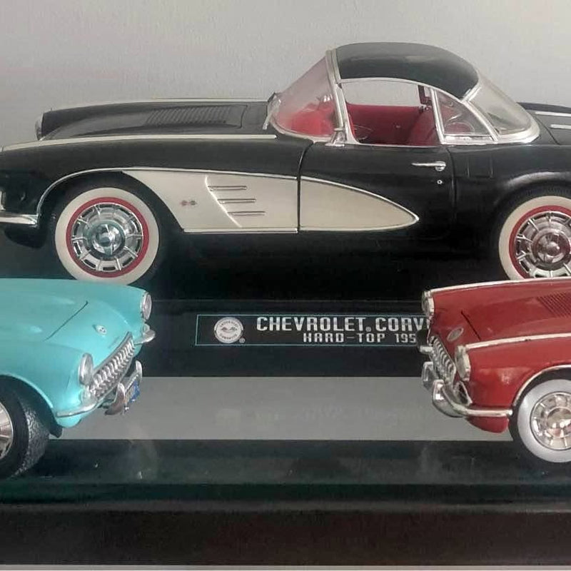Black and white diecast classic Corvette model car with red interior, front view