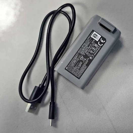 AC power adapter with attached cable and plug, rectangular gray housing