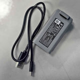 AC power adapter with attached cable and plug, rectangular gray housing