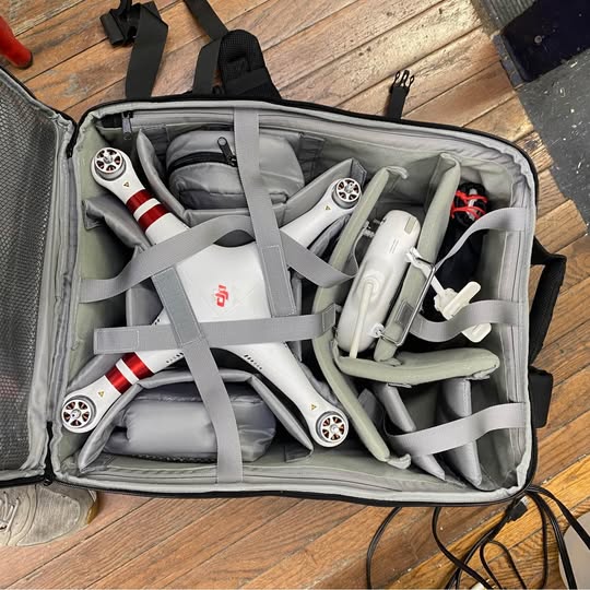 Portable drone case with grey drone and propeller guards inside