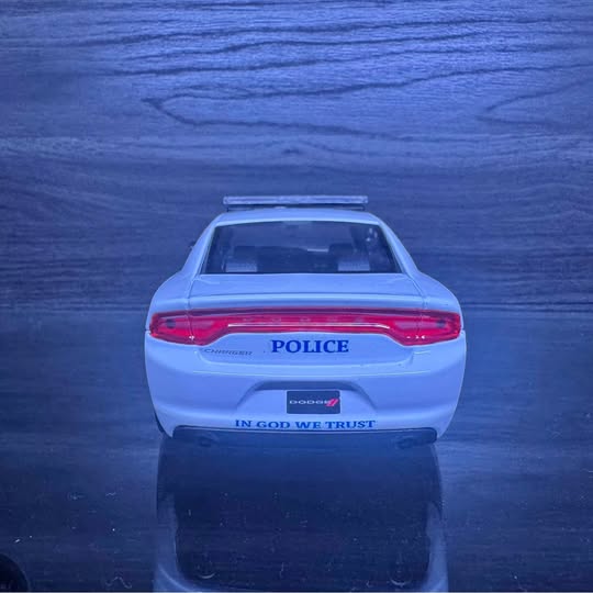 1/24 scale diecast police sedan model, rear view with POLICE badge