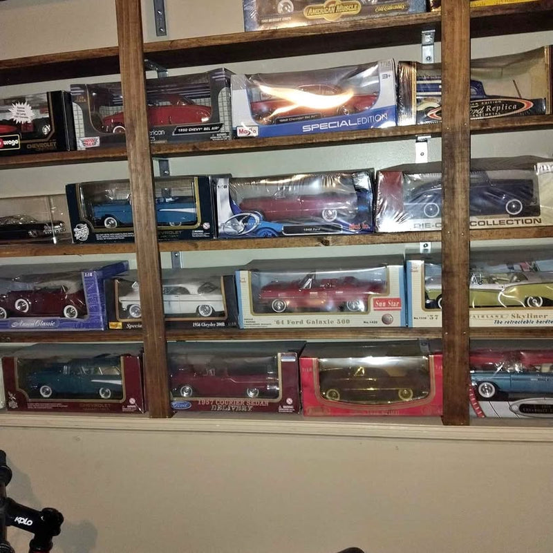 Boxed 1/18 scale diecast car models displayed on store shelf