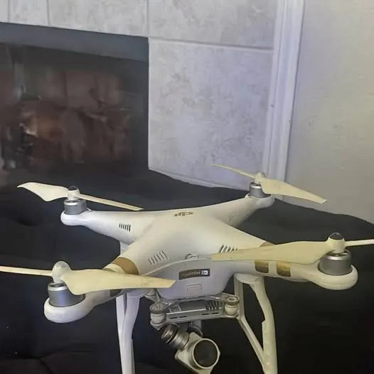 DJI Phantom drone with light body, four propellers, and front camera lens