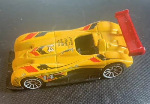 Yellow diecast race car model with red rear spoiler, #14