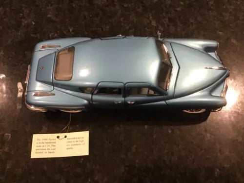 Blue diecast model car with silver finish, front 3/4 view