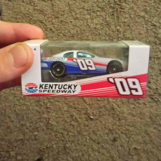 Diecast NASCAR race car in retail box, blue-red design with #09