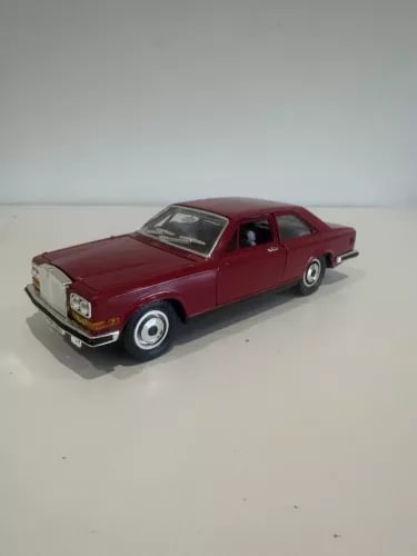 Red diecast model car of Rolls Royce Camargue, front three-quarter view