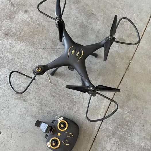 Black quadcopter drone with four propellers and LED lights