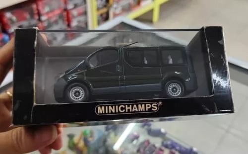 Diecast car model in black display box with MINICHAMPS logo, dark vehicle front view