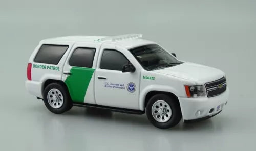 Diecast SUV model toy in white with green side stripe, front 3/4 view