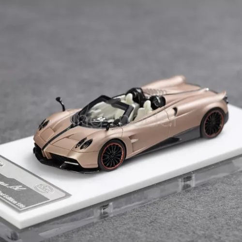Beige convertible sports car diecast model with black wheels, on display base