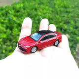 Red diecast model car with black windows and front grille detail