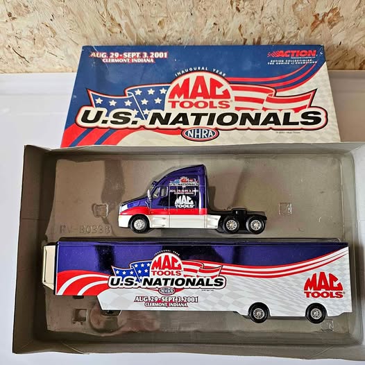 Diecast semi-truck set in box, white cab with blue and red racing graphics and trailer.