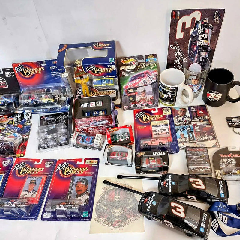 NASCAR diecast car collection with boxed cars, trading cards, and accessories