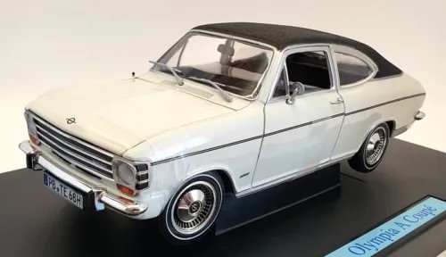 White coupe diecast car model with black roof, front three-quarter view
