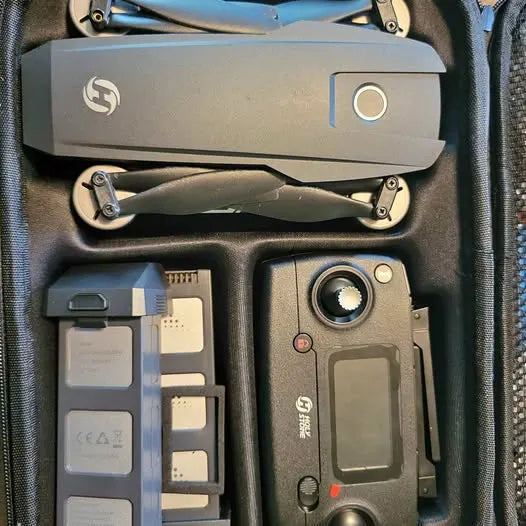 Folding drone kit with controller, spare batteries, and accessories in case