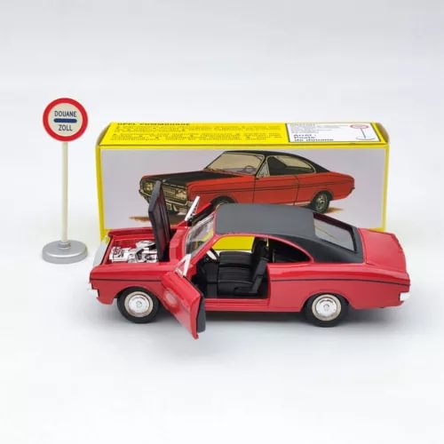 Red diecast car model with open door and hood, displayed in retail box