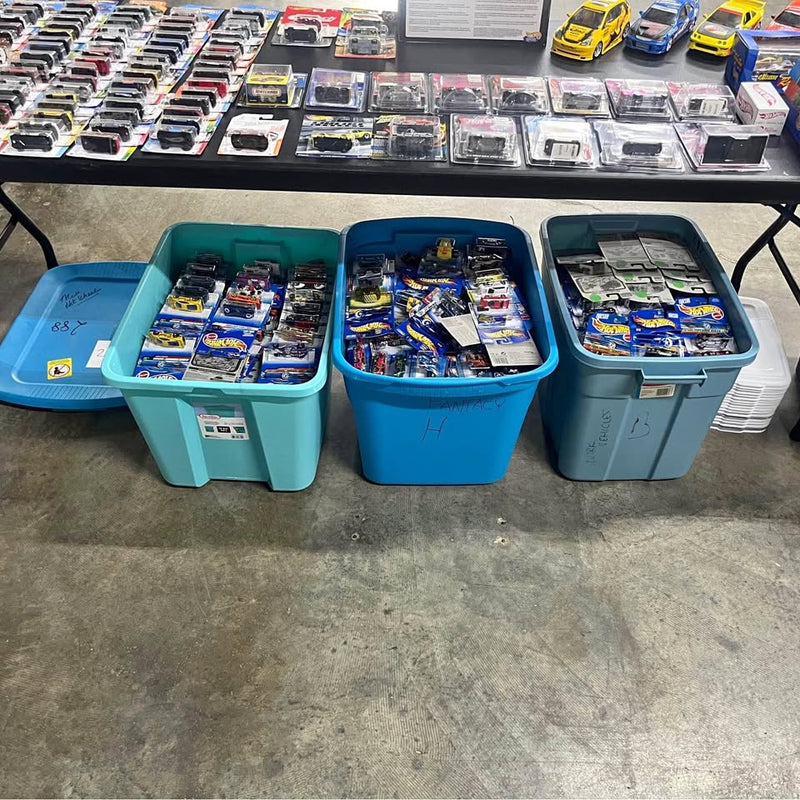 Toy diecast car assortment in three plastic storage bins, various colorful cars