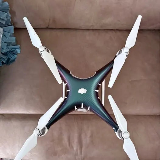 DJI Phantom Pro 4 drone with four white propellers and teal body