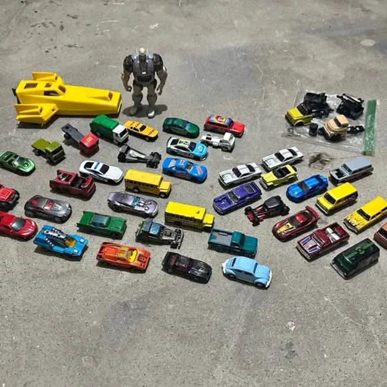 Assorted diecast miniature cars, mixed colors, with small racing and classic styles