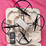 White TELLO drone with four propellers and central camera body