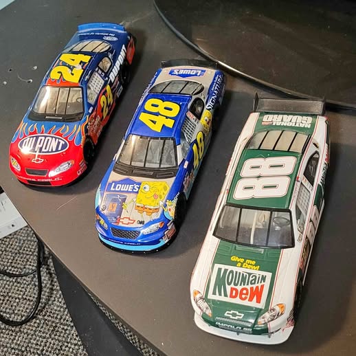 Diecast race car set with blue, red, and green numbered livery cars