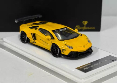 Yellow diecast sports car toy with black wheels, front 3/4 view