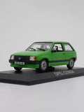 Green Opel Corsa hatchback diecast car model with display base